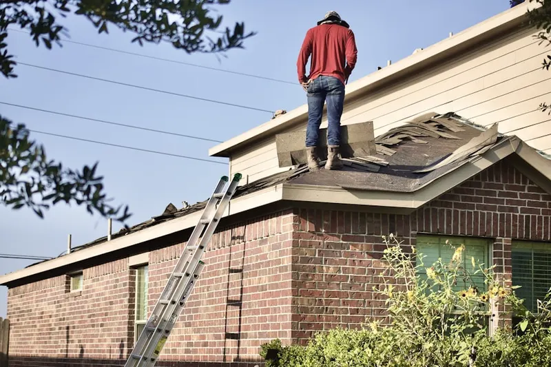 Professional roofer working on a residential roof in Edgewater Landing
